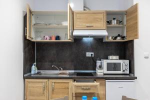 a kitchen with a sink and a microwave at E-home Apartments in Varna City