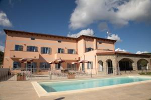 a large building with a pool in front of it at Antichi Ricordi - Le Giare in Molino Nuovo
