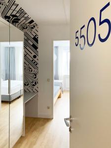 a room with a bed and a door with a sign at Stadthotel Hollabrunn in Hollabrunn