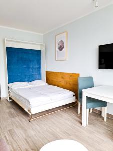 Ένα ή περισσότερα κρεβάτια σε δωμάτιο στο Hotel Sympozjum & SPA