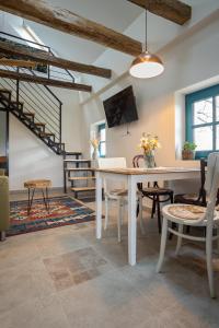 a dining room with a table and chairs at Stüble Loft in Somogyhárságy +42 photos
