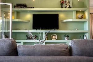 a living room with a couch and a tv at Kotrona Farmhouse - Argassi Zakynthos in Argasi