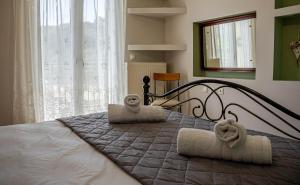 a bedroom with a bed with towels on it at Kotrona Farmhouse - Argassi Zakynthos in Argasi
