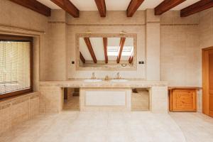 a large bathroom with a sink and a mirror at Alpinum Chalet High Tatras in Nová Lesná +17 photos