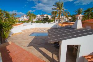 a view of a villa with a pool and a lighthouse at Villa Corina - Plusholidays in Ifach