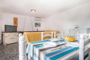 a dining room with a table with a blue and white table cloth at Villa Corina - Plusholidays in Calpe