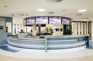 a lobby with a counter with monitors on it at Rafa Nadal Residence in Manacor +64 photos