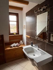 a bathroom with a sink and a window and a tub at Chata Wetłyna I in Wetlina