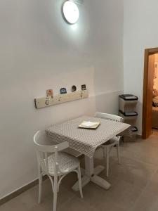 a table with two chairs and a table and a light at Casa Buena Vida (locazione ad uso turistico) in Monopoli