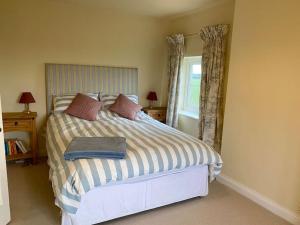 a bedroom with a bed and a window at Field House in Norwich