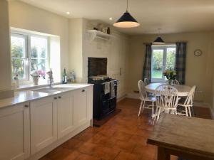 a kitchen with a table and a kitchen with a dining room at Field House in Norwich