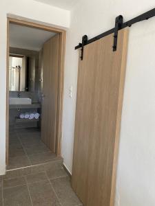 a bathroom with a sliding door in a room at XALAKAS SUMMER HOUSE in Empourios