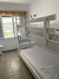 a room with two bunk beds and a window at XALAKAS SUMMER HOUSE in Empourios