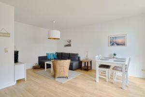 a living room with a couch and a table at Ferienwohnung Sonnendeck Moba-Travel in Priwall