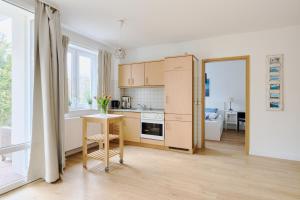 a kitchen with a table and a counter top at Ferienwohnung Sonnendeck Moba-Travel in Priwall