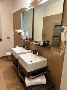 a bathroom with two sinks and a large mirror at Dolce Vita Guest House in Rome