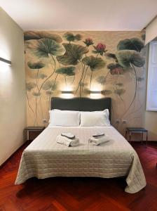 a bedroom with a bed with a flower mural on the wall at Dolce Vita Guest House in Rome