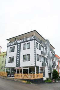 a white building with a sign that reads energy transformations at Erbay Mansions Hotel in Trabzon