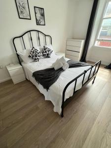 ロンドンにあるFully equipped 2 bed flat on Old Compton St!の白いシーツと枕が備わったベッドのある寝室
