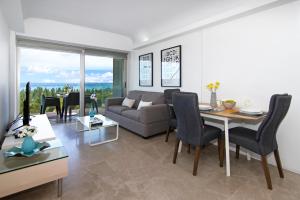 a living room with a couch and a table at Apartment Josephine - Beachfront in Protaras
