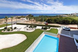 an aerial view of a resort with a swimming pool at Apartment Josephine - Beachfront in Protaras