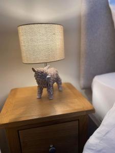 a small toy elephant on a nightstand next to a lamp at The New Forest Inn in Lyndhurst