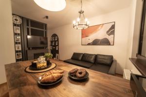 a living room with a table with bread on it at BlackWood Apartment Zlatibor in Zlatibor