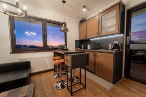 a kitchen with a counter and some windows at BlackWood Apartment Zlatibor in Zlatibor