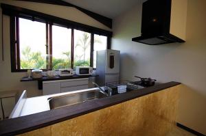 a kitchen with a sink and a refrigerator at リゾートイン青の洞窟 in Ishigaki Island