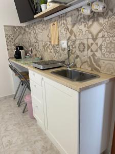 a kitchen with a sink and a counter at Nova Home in Catania