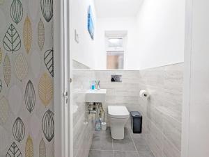 a bathroom with a white toilet and a sink at Cissa in Chichester +19 photos