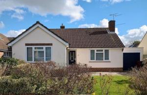 a white house with a brown roof at Cissa in Chichester