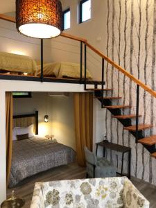 a bedroom with a bunk bed and a staircase at Botë Farms Agriturismo in Sarandë