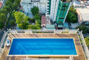 an overhead view of a large swimming pool in a city at Luxury Apartments with Rooftop Pool & Gym - Avalon in Ho Chi Minh City