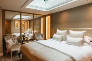 a bedroom with a large bed and a mirror at The Dean Court in York +90 photos