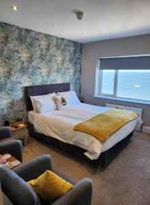 a bedroom with a bed and a large window at Morningside Hotel in Whitby