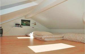 a bedroom with two beds in a attic at Amazing Home In Ask With 4 Bedrooms And Wifi in Blans