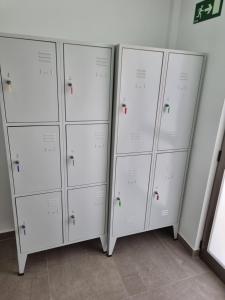 a row of white lockers in a room at APARTAMENTOS ELEMAR free luggage storage in Málaga