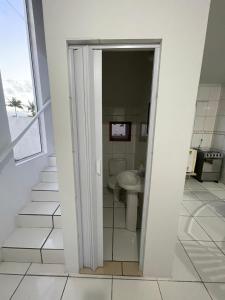 a bathroom with a toilet and a sink at Condomínio Serra da Saudade in Piçarras +6 photos