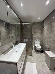 a bathroom with a white sink and a toilet at Arenya Home in Istanbul