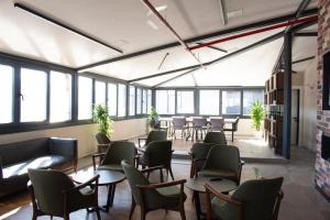 a large room with tables and chairs and windows at Arenya Home in Istanbul