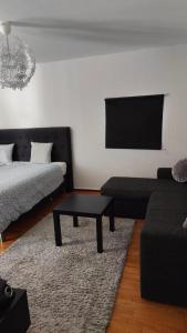 a living room with a couch and a coffee table at Very Nice Apartment 15 minutes from Stockholm in Trångsund