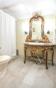 a bathroom with a sink and a mirror at WelcomHeritage Grace Hotel in Dharamshala