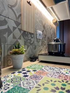 a kitchen with a stove and a rug on the floor at Nova Home in Catania