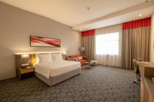 Postel nebo postele na pokoji v ubytování Peony Hotel