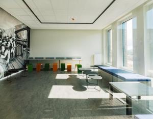 a classroom with tables and chairs in a building at Limehome Bremerhaven Kantstraße in Bremerhaven +18 photos