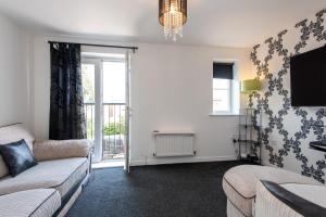 a living room with a couch and a tv at Thinford View in Spennymoor