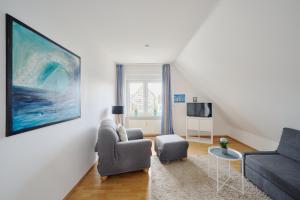 a living room with a couch and a chair at Ferienwohnung Fährnah Moba-Travel in Lübeck