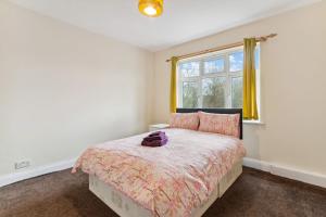 um quarto com uma cama e uma janela em Beautiful Cozy Room em Londres
