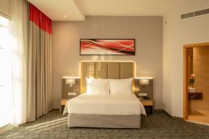 Postel nebo postele na pokoji v ubytování Peony Hotel